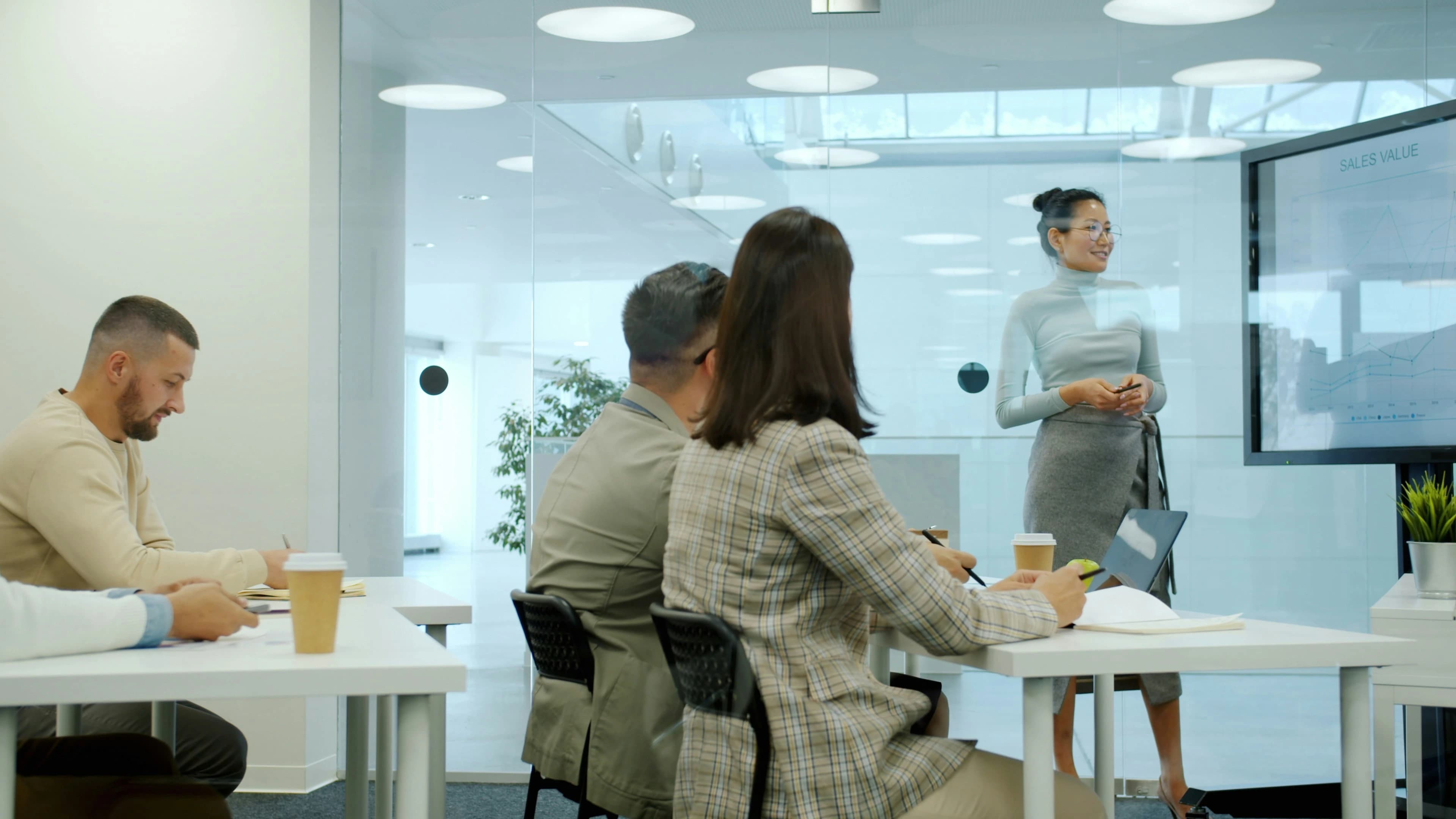 Founder delivering a startup pitch deck presentation to investors in a boardroom